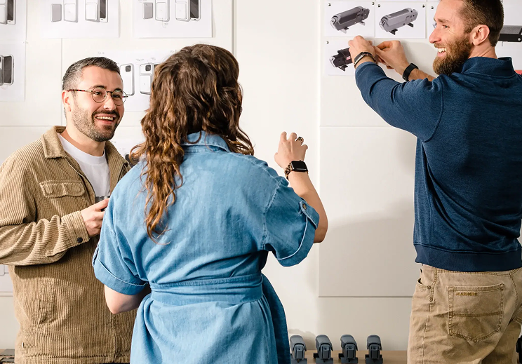 Three people discussing designs